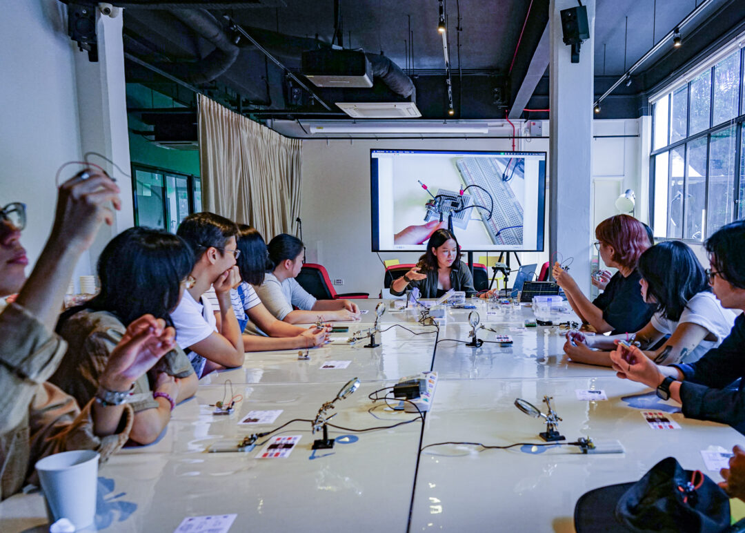 people in a workshop about electronics
