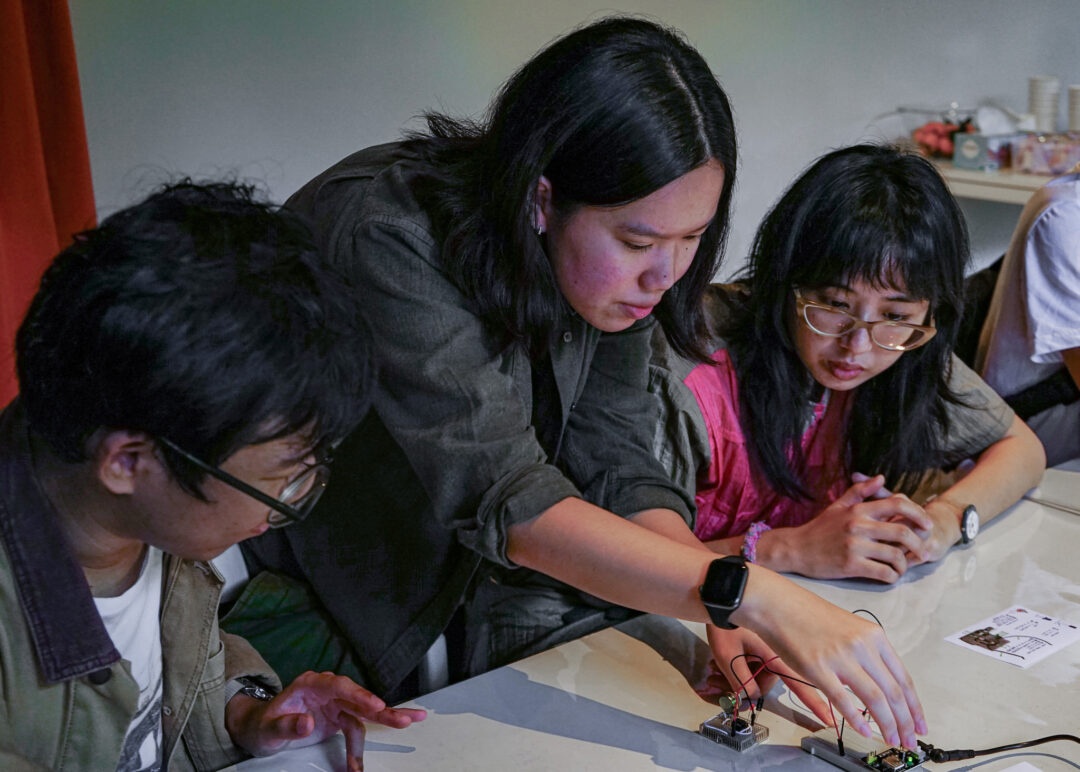 People tinkering with electronics